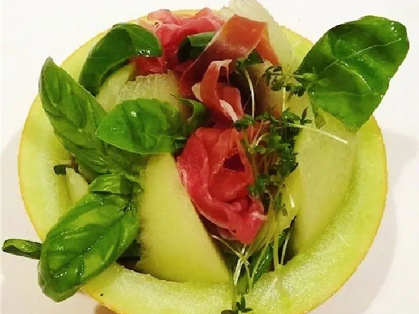 Салат в дыне с манго и прошутто